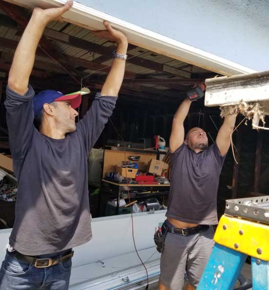 repairmen holding up garage